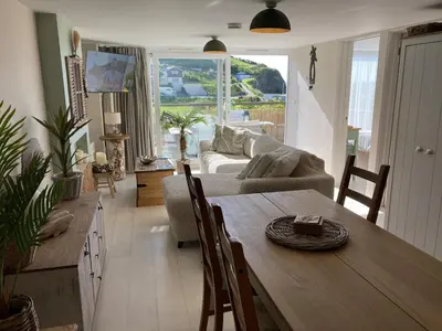 a living room with a table and a couch at Carrabee beachside haven for you & your pets in Saint Martin