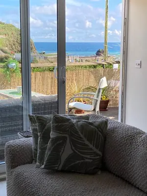 a living room with a couch and a view of the ocean at Carrabee beachside haven for you & your pets in Saint Martin