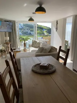 a living room with a table and a couch at Carrabee beachside haven for you & your pets in Saint Martin