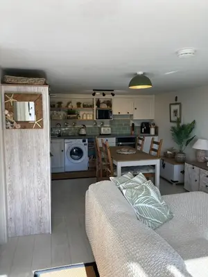 a living room with a couch and a kitchen at Carrabee beachside haven for you & your pets in Saint Martin