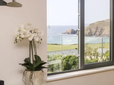 a window with a vase of flowers in a room at Praa Waves in Penzance