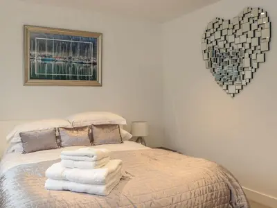 a bedroom with a bed with towels on it at Praa Waves in Penzance