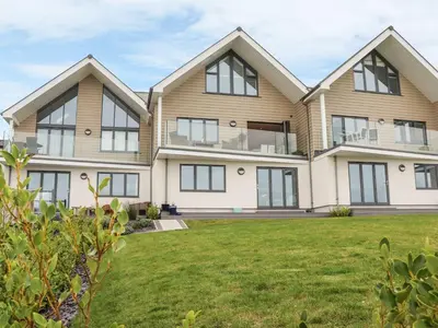 a large house with a green lawn at Praa Waves in Penzance
