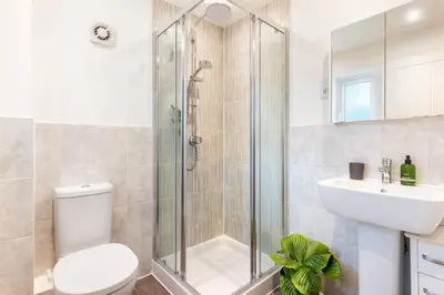 a bathroom with a shower and a toilet and a sink at Peaceful cottage near beaches - Bickland View in Falmouth