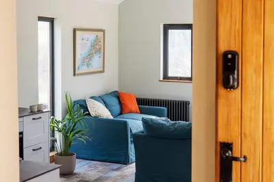 a blue couch sitting in a living room at Middle Barn at Cusgarne Manor, adults only in Cusgarne