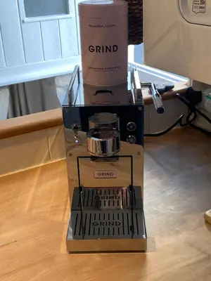 a coffee maker with a cup on top of it at SEA-AH-NA SIDE COTTAGE - Steps from the Beach Grade II Listed Refurbished Romantic Getaway in St Ives