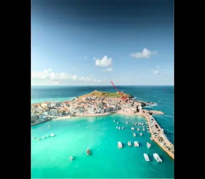 an aerial view of a small island in the ocean at SEA-AH-NA SIDE COTTAGE - Steps from the Beach Grade II Listed Refurbished Romantic Getaway in St Ives