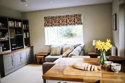 a living room with a couch and a table at Little Croft- Walking paradise close to St Ives in St Ives