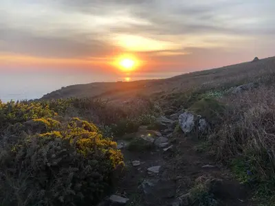 a sunset on top of a hill with a trail at Little Croft- Walking paradise close to St Ives in St Ives