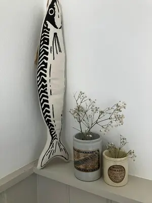 a fish decoration on a shelf next to two plants at Little Croft- Walking paradise close to St Ives in St Ives