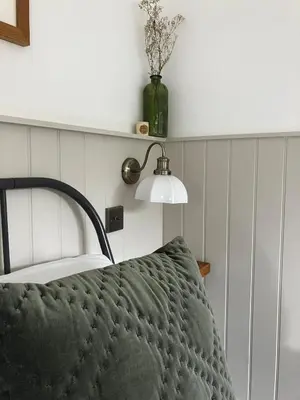 a bedroom with a bed with a lamp on it at Little Croft- Walking paradise close to St Ives in St Ives