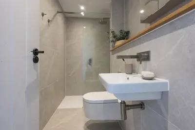 a bathroom with a sink and a toilet and a shower at 10 Cannery Row - Stunning Views - Pet Welcome - Free WiFi & Parking in Hayle