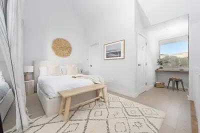 a white bedroom with a bed and a table at 10 Cannery Row - Stunning Views - Pet Welcome - Free WiFi & Parking in Hayle