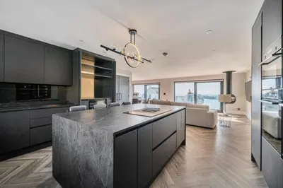 a kitchen with a large island in a living room at Seaglass Point in Mevagissey