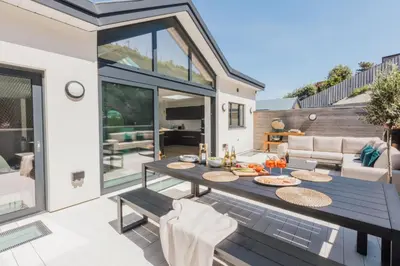 a patio with a table with food on it at Ocean Skies in Porthtowan