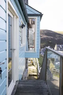 a stairway leading up to a house with a window at Oceans Edge in Portreath