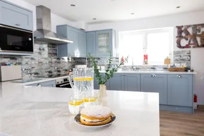 a kitchen with a counter with two glasses of orange juice at The Lookout in Portreath