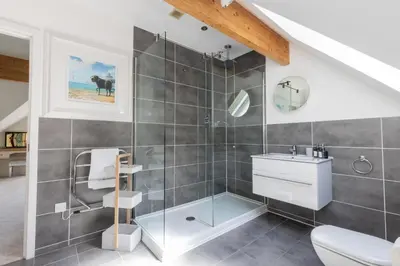 a bathroom with a shower and a toilet and a sink at The Lookout in Portreath