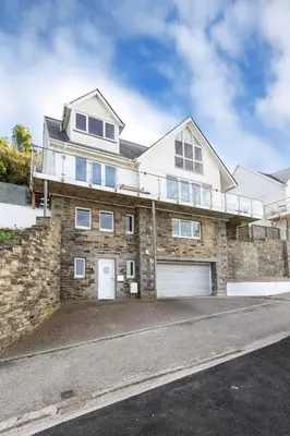 a large brick house with a garage at The Lookout in Portreath
