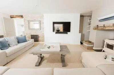 a living room with a couch and a table at The Tide House in St Ives