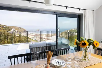 a dining room with a view of the ocean at Tamarisk in Portreath
