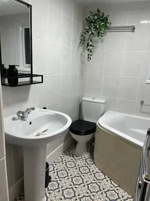 a bathroom with a sink and a toilet and a tub at Entire house by East Looe beach in Looe