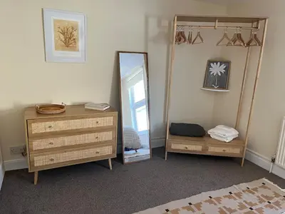 a dressing room with a mirror and a dresser at Entire house by East Looe beach in Looe