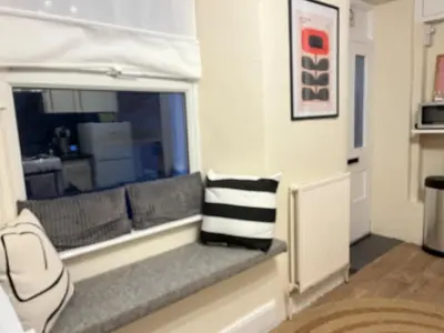 a couch in a living room with a window at Entire house by East Looe beach in Looe