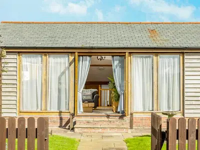 a house with large windows and a porch at The Old Smithy in Bude