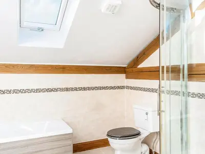 a bathroom with a toilet and a sink at The Old Smithy in Bude