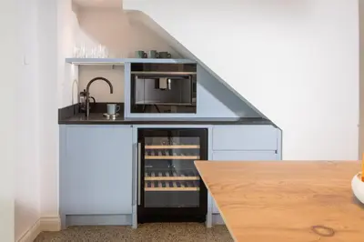 a kitchen with a counter with a sink and a microwave at Watergate View in Porth