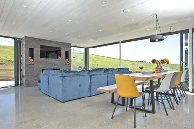 a dining room with a table and yellow chairs at Watergate Horizon in Porth