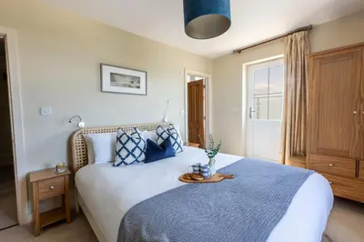 a bedroom with a bed with a tray on it at Trewalder in St Merryn