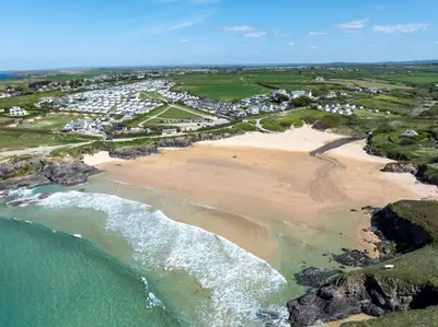 an aerial view of a beach and the ocean at Trewalder in St Merryn