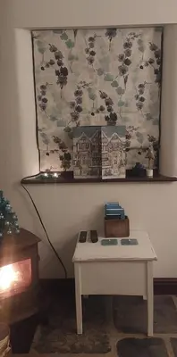 a room with a table and a picture on the wall at The Granary -Trewen in Trewen