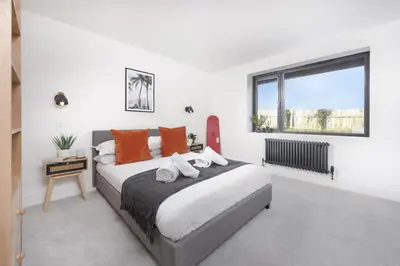a bedroom with a large bed and a window at Copper Tree in Newquay