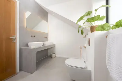 a white bathroom with a sink and a toilet at Copper Tree in Newquay