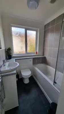 a bathroom with a toilet and a tub and a sink at Heatherbell in Carbis Bay