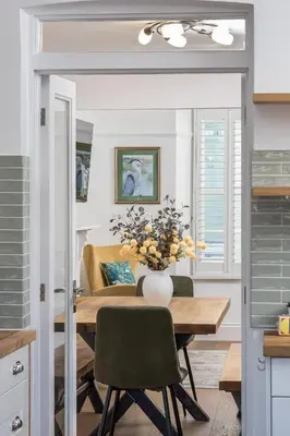 a dining room with a table and a couch at Premium 3BR Cottage Sauna EV Newquay in Newquay
