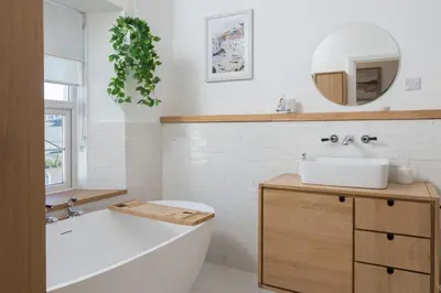 a bathroom with a tub and a sink and a mirror at Premium 3BR Cottage Sauna EV Newquay in Newquay