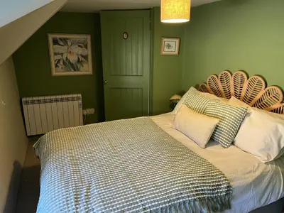 a bed in a bedroom with green walls at 3 Bed in St. Merryn oc-l34453 in St Merryn