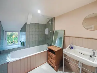 a bathroom with a tub and a sink and a mirror at 3 Bed in St. Merryn oc-l34453 in St Merryn