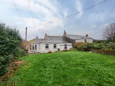 a white house with a green lawn in front of it at 3 Bed in St. Merryn oc-l34453 in St Merryn