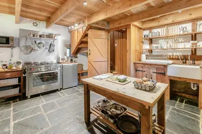 a large kitchen with wooden ceilings and a wooden table at 1 Bed in St. Austell oc-b33396 in St Austell
