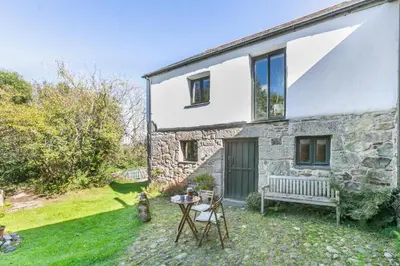 a stone house with a bench in the yard at 1 Bed in St. Austell oc-b33396 in St Austell