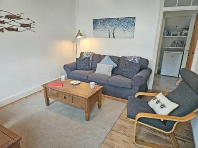 a living room with a couch and a coffee table at Kenwith Cottage in Looe