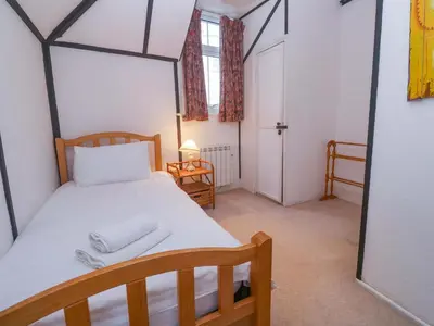 a bedroom with a bed with two towels on it at Pelican Cottage in St Ives