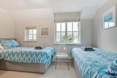 a bedroom with two beds and a chair in it at 2 Bed in Padstow oc-p00337 in Padstow
