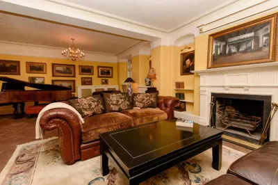 a living room with a couch and a fireplace at Ladye Park in Liskeard