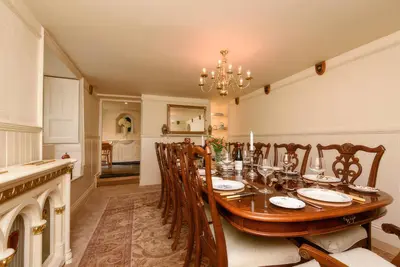 a dining room with a wooden table and chairs at Ladye Park in Liskeard